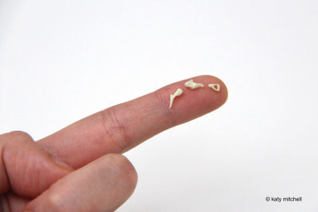 Ear ossicles - three tiny bones shown on a finger tip