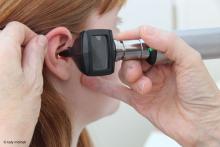photograph using an otoscope to look at the ear drum